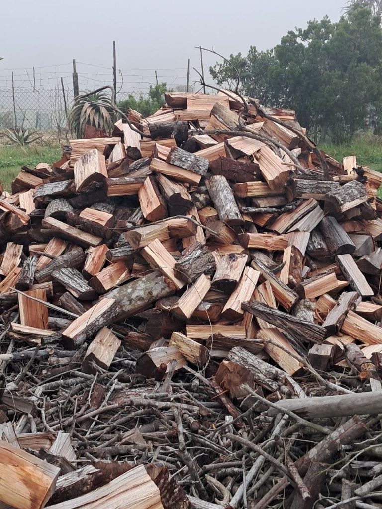 Split black wattle braai wood stacked in a pile at BraaiWattle, Wilderness