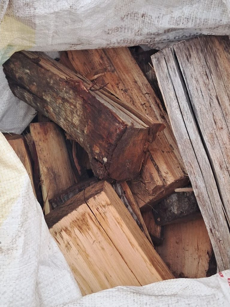 A sack packed with dry split wattle logs, ready for delivery